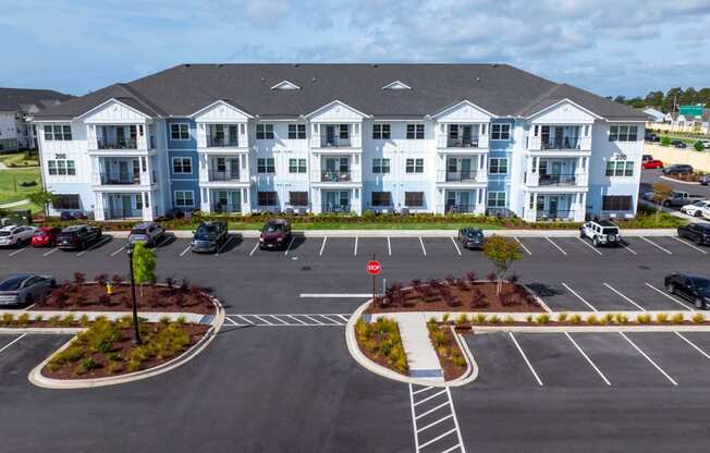 an aerial view of an apartment building in a parking lot