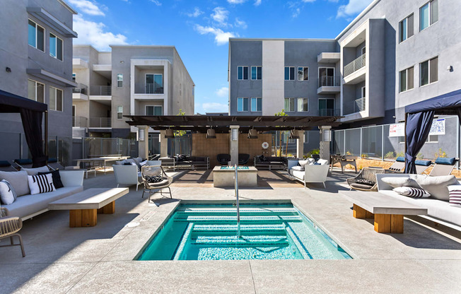 A modern outdoor living space with a pool and lounging area.