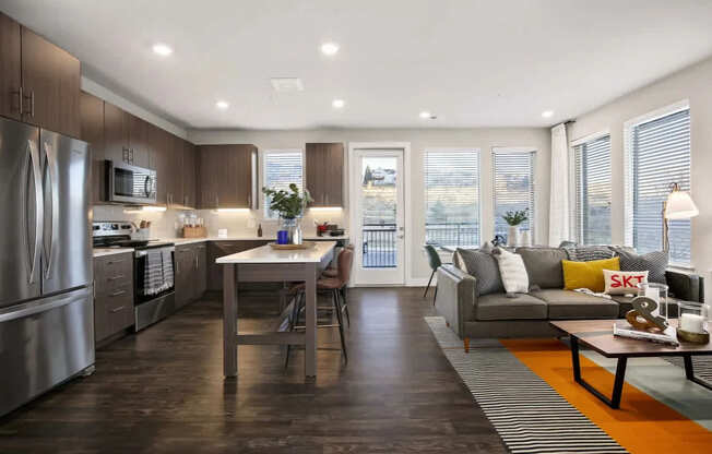 A modern kitchen with a dining table and a couch.