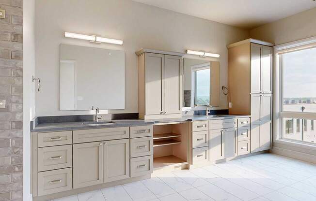 A spacious ensuite bathroom featuring a quartz double vanity with taupe cabinetry, a tall storage cabinet, and tiled flooring.