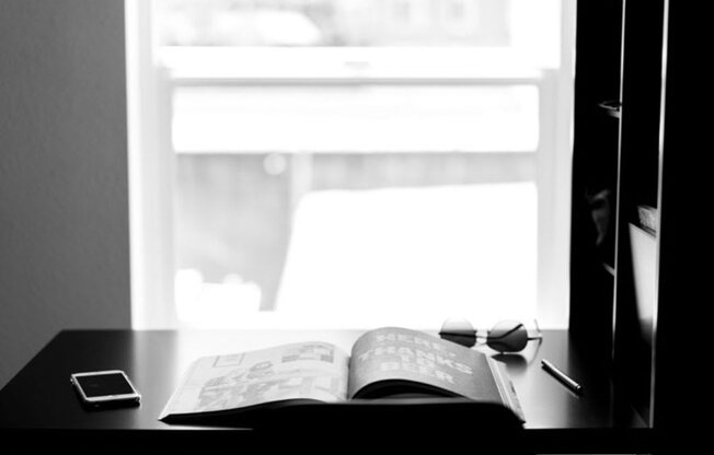 a book sitting on top of a desk next to a window