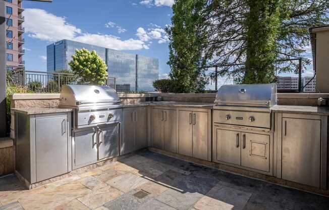 A stainless steel outdoor kitchen with a grill and sink.