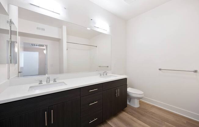 A bathroom with a white countertop and a white toilet.