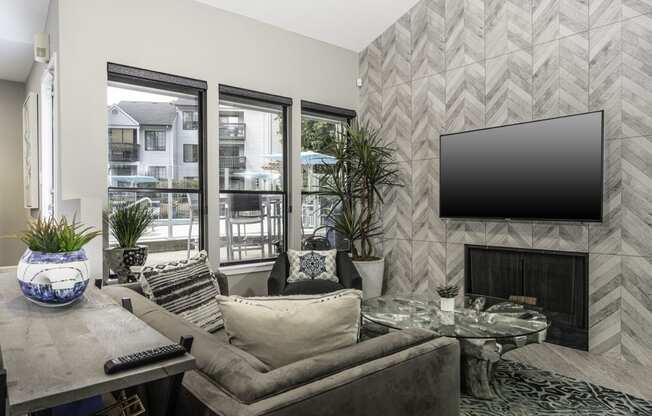 a living room with a fireplace and a tv on the wall