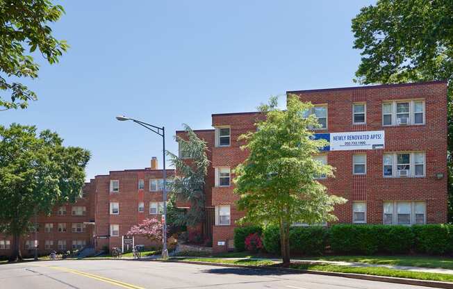 a large red brick building on the corner of a street