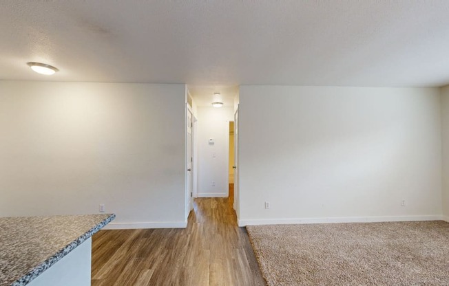 a living room with white walls and hardwood floors at Bennett Ridge Apartments, Oklahoma City, Oklahoma