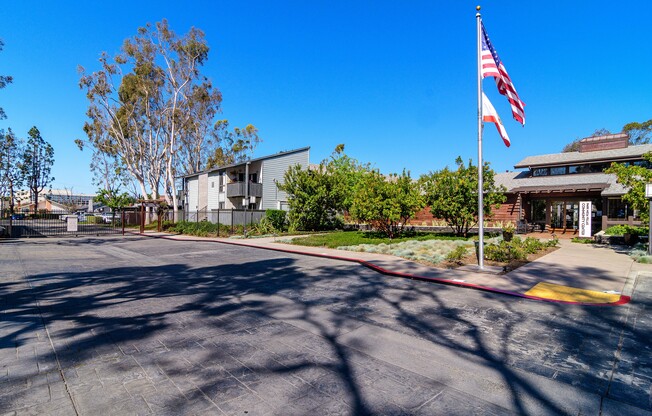 A parking lot with a flag pole in the middle.