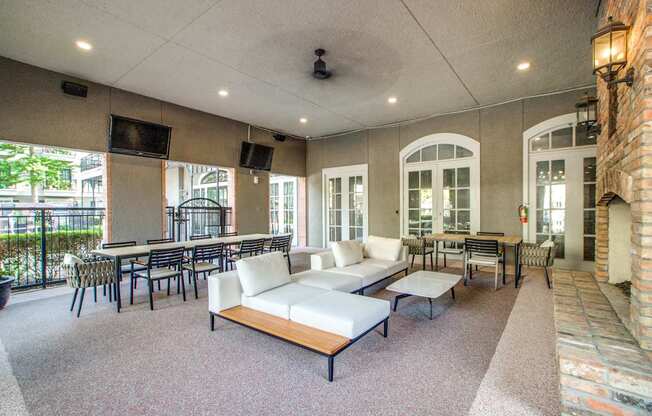 A large room with a white couch and a long table.