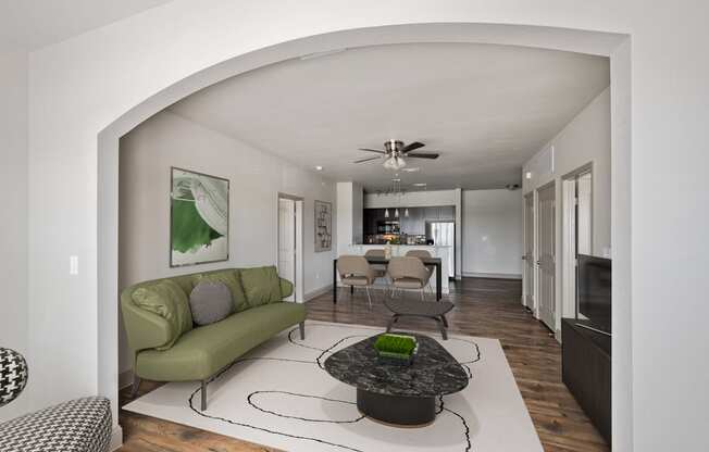 a living room with a green couch and a coffee table