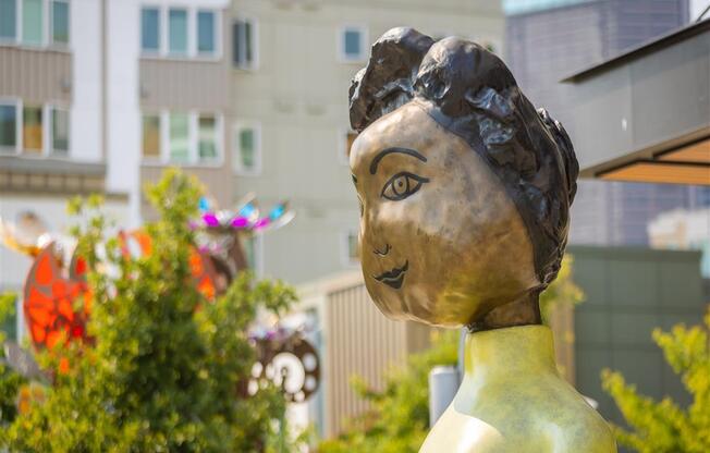 a statue of a woman in front of a building