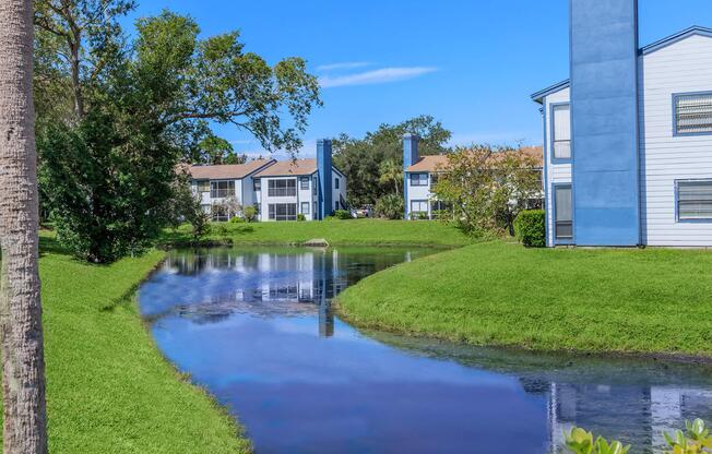 a house with a lawn in front of a body of water