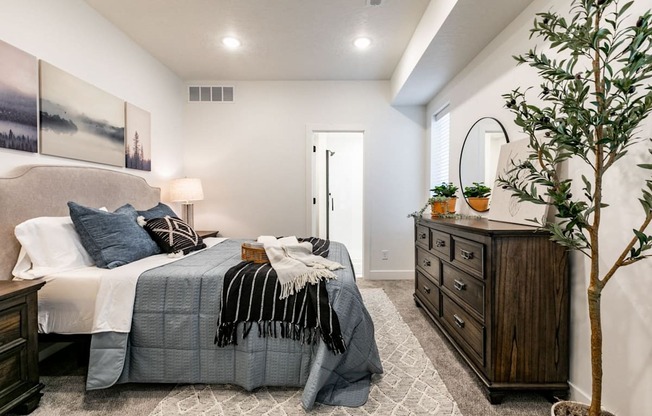 a bedroom with a bed and a dresser