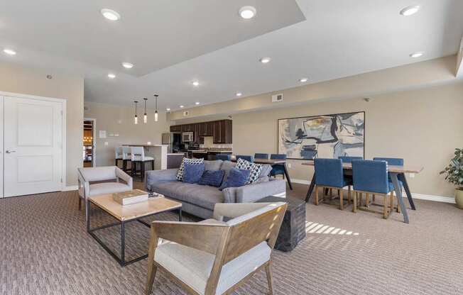 A living room with a grey couch and a wooden chair.