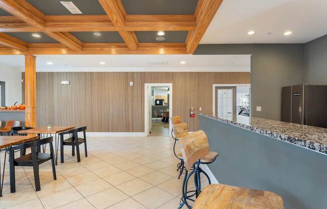 A kitchen with a bar area and a dining table.