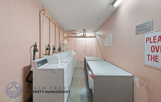 a laundry room with several washes and dryers in it