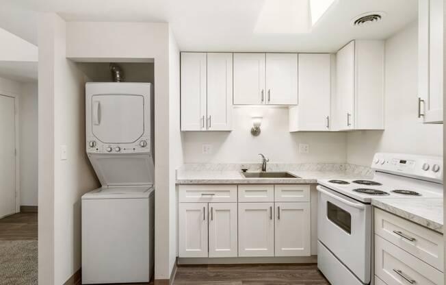 a white kitchen with white appliances and white cabinets at Park View Apartments, Wenatchee, WA