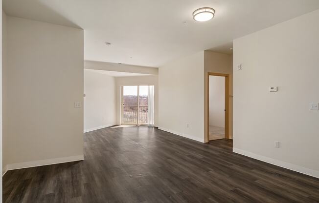 Living room with wood flooring, white walls and overhead lighting.at Shoreline Village, Richland, 99352