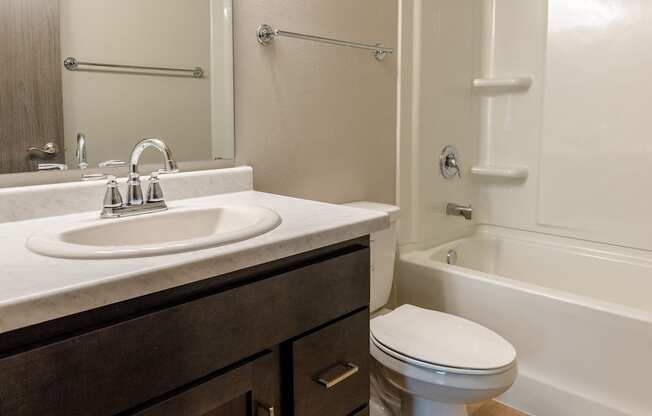 A bathroom with sink toilet and shower. Fargo, ND Granger Court Apartments.