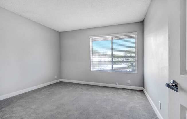 the living room of an empty house with a window