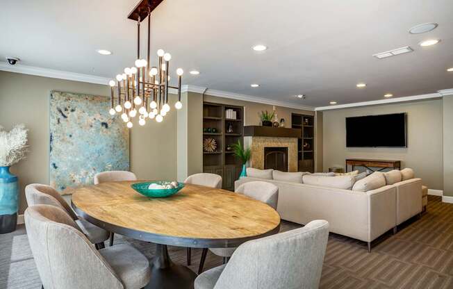 A modern dining room with a wooden table and chairs.