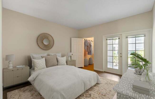 A bedroom with a large bed, a dresser, and a window.