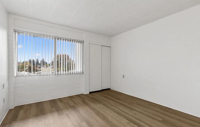 A room with a window overlooking a street.