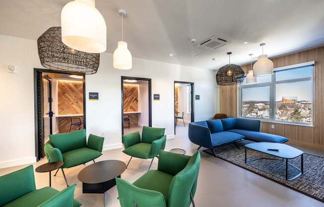 A living room with green chairs and a blue sofa.