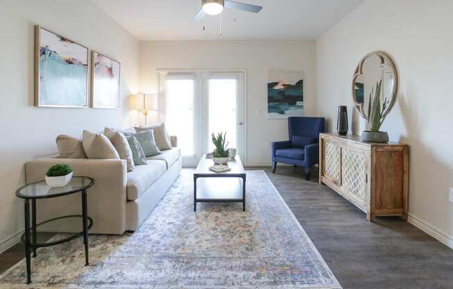 a living room with a white couch and a blue chair