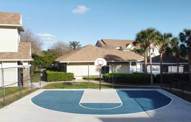 a basketball court in the backyard of a house