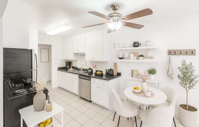 A modern kitchen with a dining table and chairs.