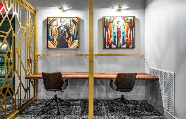 a conference room with two paintings on the wall and a wooden desk