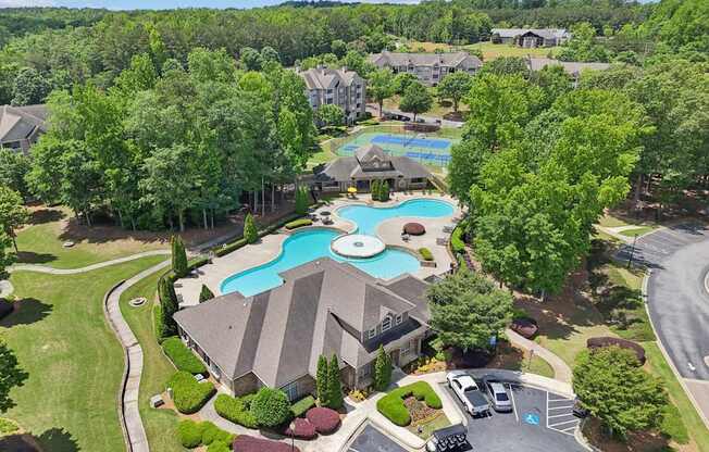 Birds eye view of the community and  a pool and  tennis court.