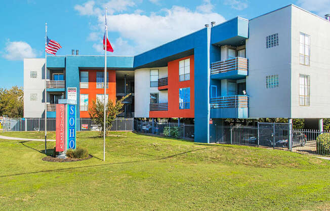 a blue and red building with flags in front of it