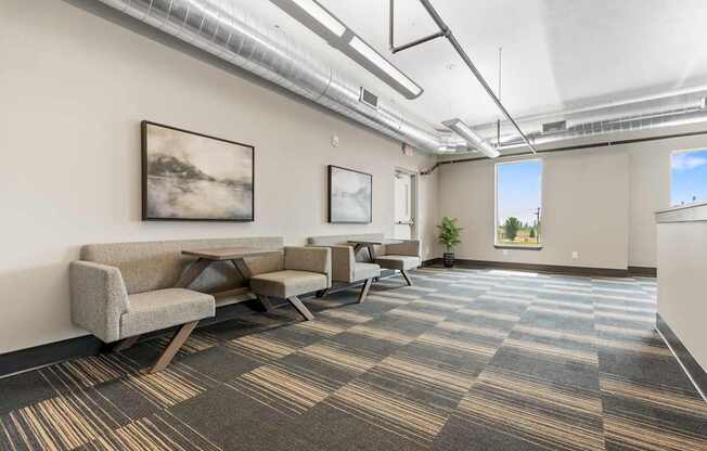A room with a carpeted floor and a couch.