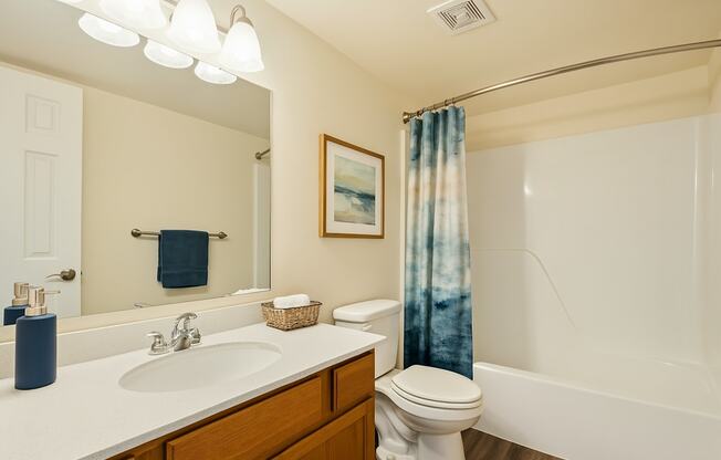 A bathroom with a white sink, toilet, and bathtub.