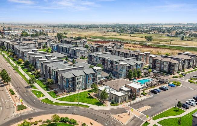 an aerial view of a city with apartment buildings and a highway