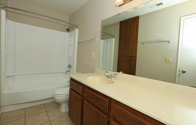 a kitchen with a sink and a mirror