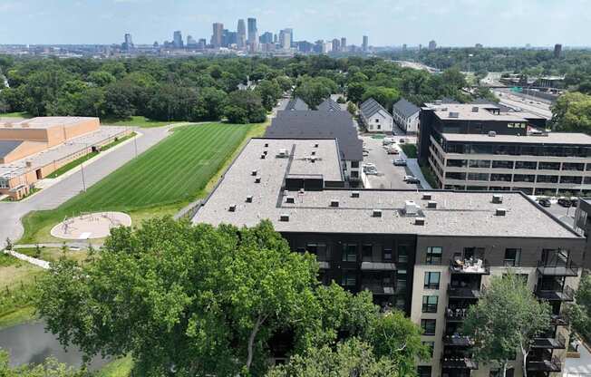 an aerial view of the building with the city skyline in the background