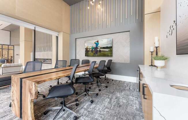 A conference room with a long table and chairs.