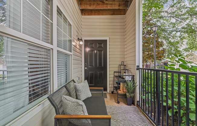 covered patio with a chair and a table