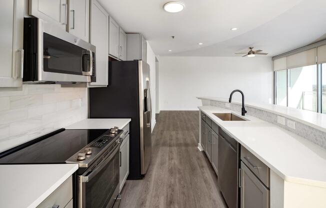 a kitchen with an island and a stove and a microwave