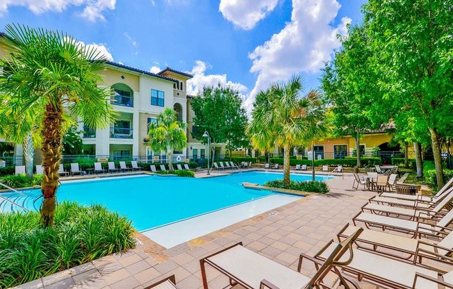 Sparkling pool with lounge chairs at Mission at La Villita Apartments in Irving, TX offers 1, 2 & 3 bedroom apartment homes with appliances.