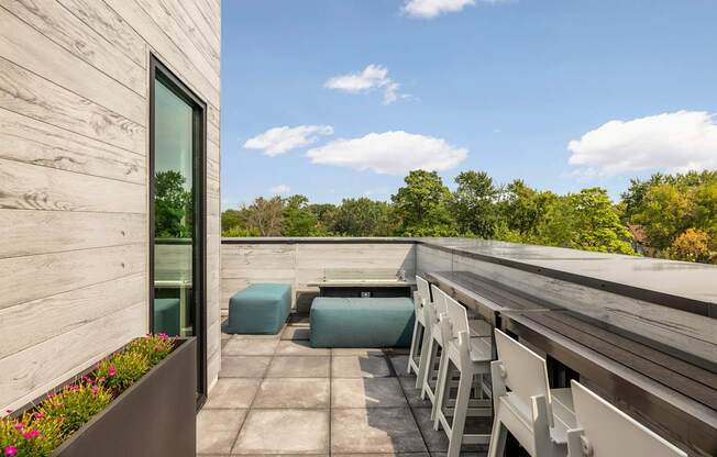 A wooden deck with chairs and a table.