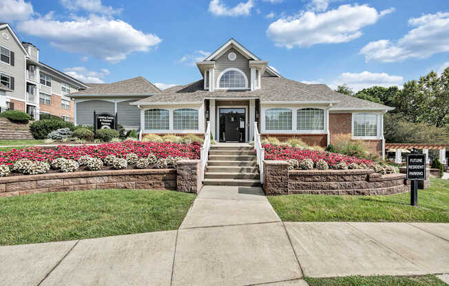 A house with a front yard and a sign that says "For Sale".
