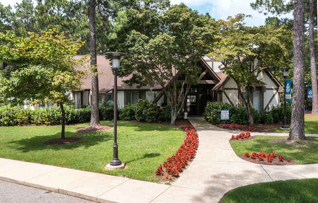 A house with a brown roof and a green lawn.