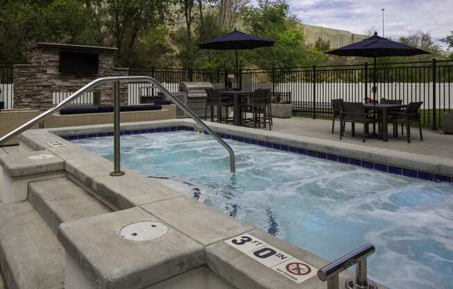 outdoor hot tub and a patio with tables