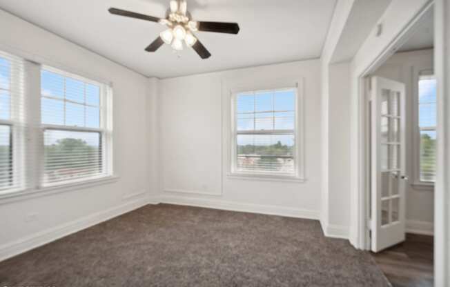 a living room with a carpet and a ceiling fan at CWE Apartments, St. Louis, MO, 63108