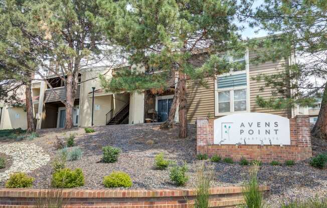 a view point apartments building with a sign and trees