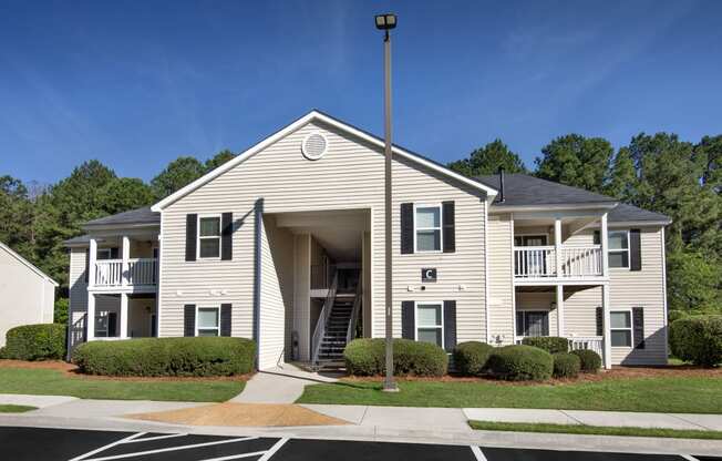 an apartment building with a porch and a street light