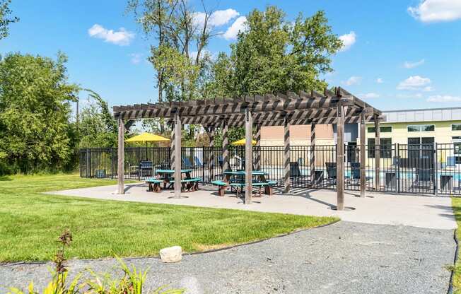 A park with a pavilion and picnic tables.